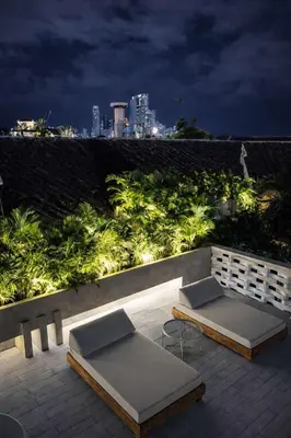 two beds sitting on a patio at night at NOK Award Winning 4BR Villa wih pool at Getsemani in Cartagena de Indias