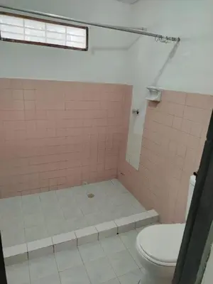 a bathroom with a pink tiled shower with a toilet at Entire house in Cartagena in Cartagena de Indias