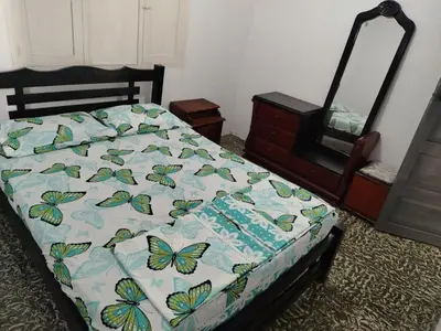 a bed with a quilt with butterflies on it at Entire house in Cartagena in Cartagena de Indias