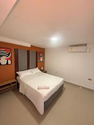 a bedroom with a large bed in a room at Hotel CARTAGENA ES in Cartagena de Indias