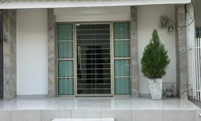 a plant in a vase sitting outside of a building at Apartamento coral del mar in Tolú