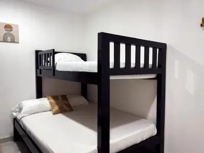 two black bunk beds in a room at Apartamento coral del mar in Tolú