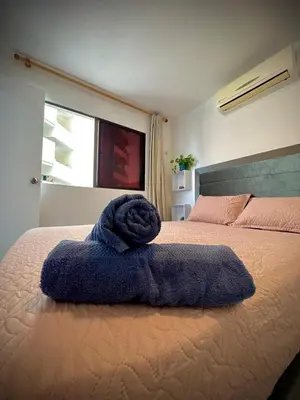 a blue towel sitting on top of a bed at Vista soñada cerca al mar y centro histórico in Cartagena de Indias