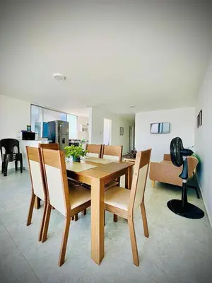 a dining room with a wooden table and chairs at Vista soñada cerca al mar y centro histórico in Cartagena de Indias