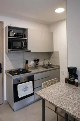 a kitchen with a stove and a counter top at Apartamento en Santa Marina in Santa Marta