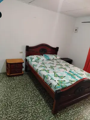 a bedroom with a bed and a nightstand next to a bed sidx sidx sidx at Apt at the foot of the stern in Cartagena de Indias