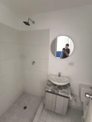 a man taking a picture of a bathroom with a mirror at cartagena luxury in Cartagena de Indias