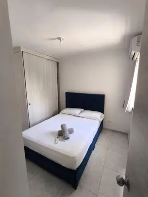 a small bedroom with a bed with a book on it at cartagena luxury in Cartagena de Indias
