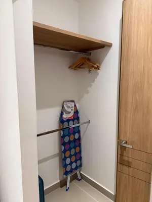 a room with a closet with a shelf and a suitcase at Luxy 2BR at paradise Oasis, 18 min from walled city in Cartagena de Indias