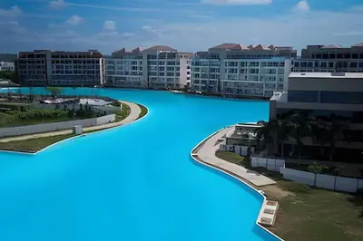a large pool of blue water in a city at Luxy 2BR at paradise Oasis, 18 min from walled city in Cartagena de Indias