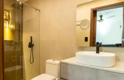 a bathroom with a toilet and a sink and a shower at Casa en conjunto cerrado, frente al mar in Santa Marta