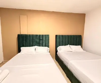 two beds sitting next to each other in a room at Casa Mercedes Cartagena in Cartagena de Indias