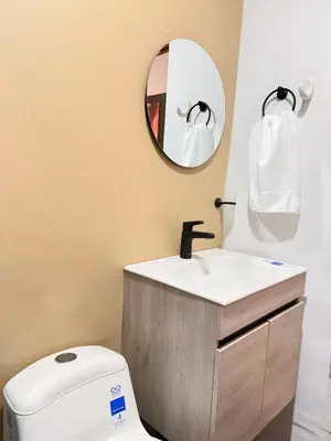 a bathroom with a white toilet and a mirror at Casa Mercedes Cartagena in Cartagena de Indias