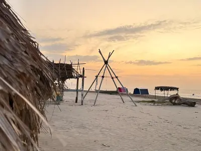 a windmill on a beach with the ocean in the background at Casa Mercedes Cartagena in Cartagena de Indias