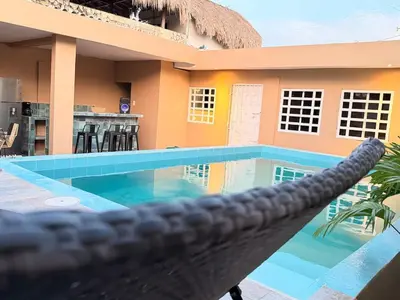 a swimming pool in front of a house at Casa Mercedes Cartagena in Cartagena de Indias