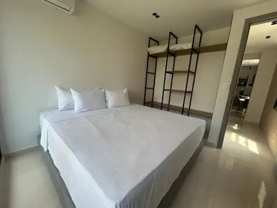 a bedroom with a white bed with white sheets and pillows at Habitación Edificio Shanty 203 in Barranquilla