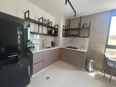 a kitchen with a refrigerator and a sink in it at Habitación Edificio Shanty 203 in Barranquilla