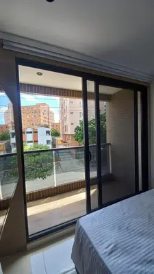 a bedroom with a large window with a view at Habitación Edificio Shanty 203 in Barranquilla