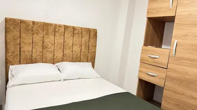 a bedroom with a bed with a wooden headboard at apartamento cercano a la playa de Marbella Canapote in Cartagena de Indias