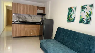 a living room with a couch and a kitchen at apartamento cercano a la playa de Marbella Canapote in Cartagena de Indias