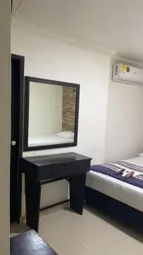 a bedroom with a mirror and a black table at Hotel Avanty Barranquilla in Barranquilla