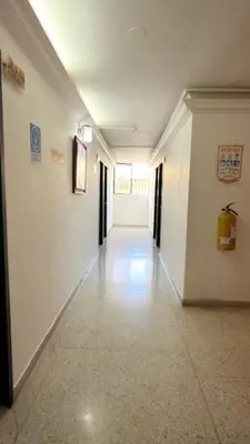 a hallway in a building with white walls and white floors at Hotel Avanty Barranquilla in Barranquilla