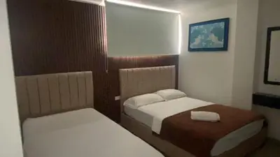 a room with two beds and a window at Hotel Avanty Barranquilla in Barranquilla