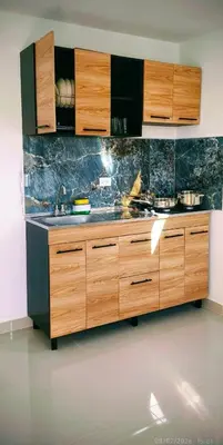 a kitchen with wooden cabinets and a sink at Brisa y Rio Apartamento en Norte Centro historico in Barranquilla