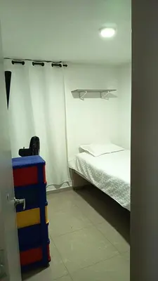 a bedroom with a bed and a dresser in a room at Apartamento Hermoso in Barranquilla