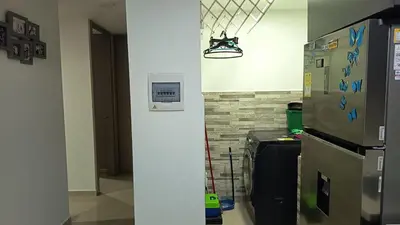 a kitchen with a refrigerator and a wall at Apartamento Hermoso in Barranquilla
