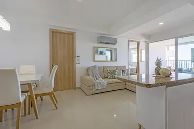 a kitchen and living room with a couch and a table at Bocagrande Summer Beach - Primera linea de mar in Cartagena de Indias