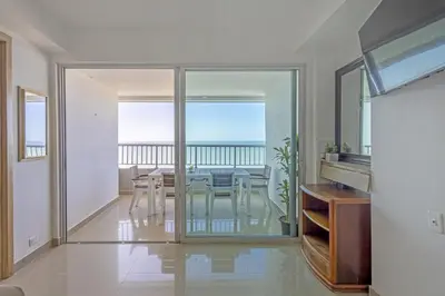 a dining room with a table and a view of the ocean at Bocagrande Summer Beach - Primera linea de mar in Cartagena de Indias