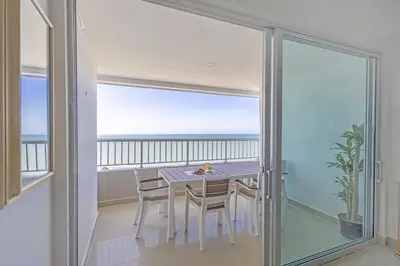 a dining room with a table and a view of the ocean at Bocagrande Summer Beach - Primera linea de mar in Cartagena de Indias