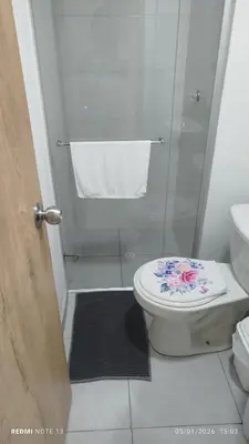 a bathroom with a toilet and a shower with a glass door at Apartamento en cartagena vista al mar in Cartagena de Indias