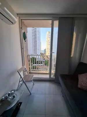 a living room with a chair and a large window at Apartamento en cartagena vista al mar in Cartagena de Indias