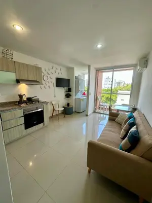 a large living room with a couch and a kitchen at Confort y Estilo en el Norte de Barranquilla in Barranquilla