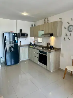 a large kitchen with a refrigerator and a stove at Confort y Estilo en el Norte de Barranquilla in Barranquilla