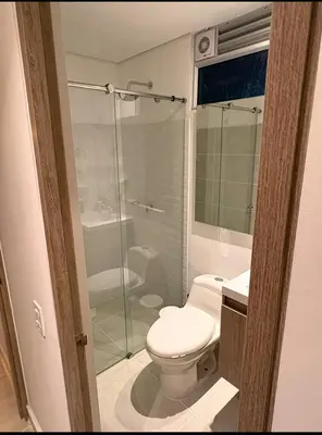 a bathroom with a toilet and a glass shower at Charming Apartment Close to the Beach in Cartagena de Indias