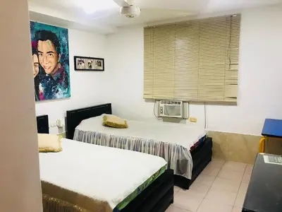 a room with two beds and a window at The best room in Barranquilla! in Barranquilla