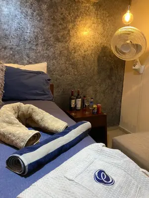 a bedroom with two beds with towels and a fan at hermosa habitacion in Barranquilla