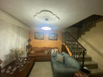 a living room with a couch and a staircase at hermosa habitacion in Barranquilla