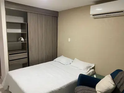 a bedroom with a white bed and a couch at Posada encanto 2 cartagena in Cartagena de Indias