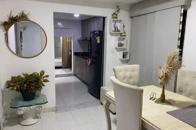 a kitchen and dining room with a table and a mirror at Posada encanto 2 cartagena in Cartagena de Indias