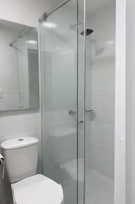 a bathroom with a glass shower with a toilet at Posada encanto 2 cartagena in Cartagena de Indias