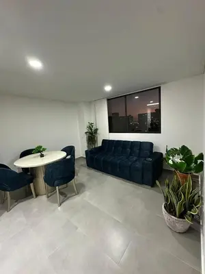 a living room with a couch and a table at Beautiful, apartment near CC Único, Estadio R Martinez in Barranquilla