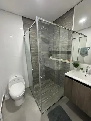 a bathroom with a shower and a toilet and a sink at Beautiful, apartment near CC Único, Estadio R Martinez in Barranquilla