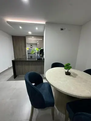 a room with a table and chairs with a bonsai on it at Beautiful, apartment near CC Único, Estadio R Martinez in Barranquilla