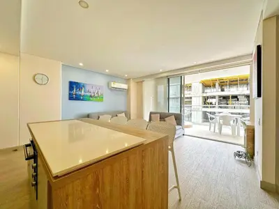 a kitchen and living room with a table and chairs at Cartagena Cielo Mar Apartment Steps from the Beach in Cartagena de Indias