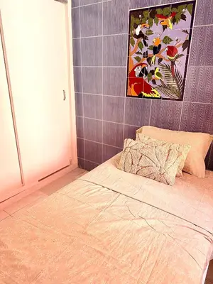 a bedroom with a bed and a painting on the wall at Casa Guayabal hostal& cocina in Cartagena de Indias