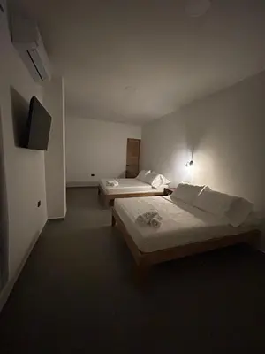 a hotel room with two beds and a television at Hotel Porton De La Sabana in San Onofre